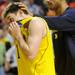 Michigan senior Stu Douglass is consoled by teammate sophomore Jon Horford as they walk off the court after losing 65-60 to Ohio University in the second round of the NCAA tournament at Bridgestone Arena in Nashville, Tenn.  Melanie Maxwell I AnnArbor.com